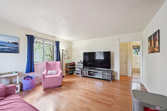 3350 W 94th Ave, Westminster, CO 80031 - living room featuring light wood-type flooring and baseboards