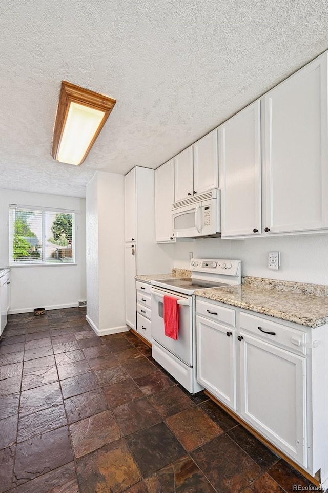 3350 W 94th Ave, Westminster, CO 80031 - kitchen featuring white appliances, white cabinetry, a textured ceiling, stone tile floors, and light stone counters