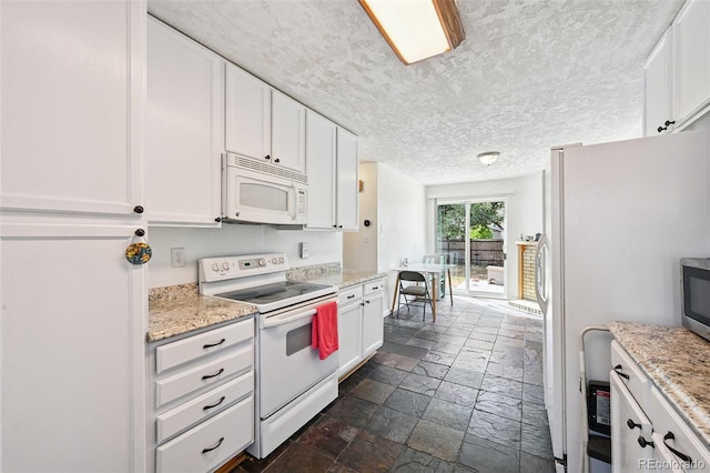 3350 W 94th Ave, Westminster, CO 80031 - kitchen with white appliances, stone tile floors, white cabinetry, a textured ceiling, and light stone countertops