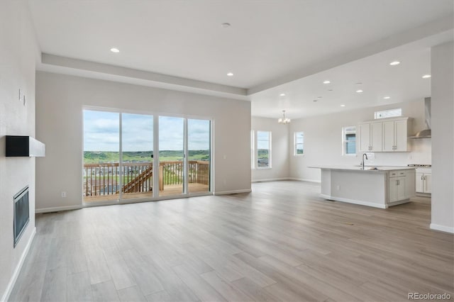 4716 Twelve Oaks Way, Castle Rock, CO 80104 - unfurnished living room featuring a sink, baseboards, a large fireplace, a chandelier, and recessed lighting