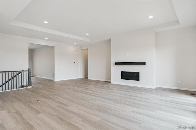 4716 Twelve Oaks Way, Castle Rock, CO 80104 - unfurnished living room with light wood-style flooring, recessed lighting, a glass covered fireplace, and baseboards