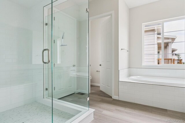 4716 Twelve Oaks Way, Castle Rock, CO 80104 - bathroom with a stall shower, a bath, wood finished floors, and toilet