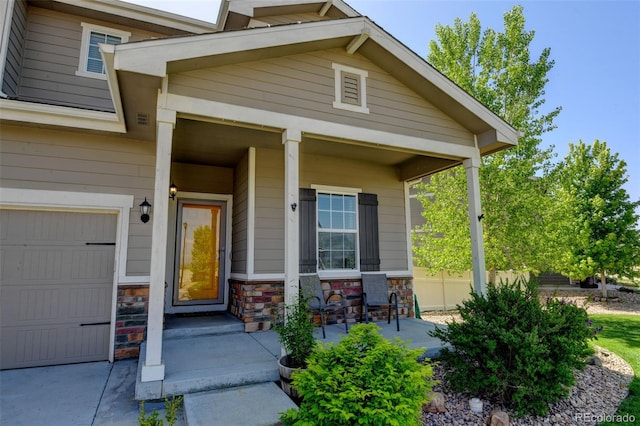 property entrance featuring a porch and stone siding
