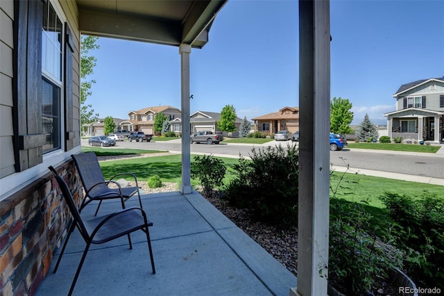 view of patio with covered porch and a residential view