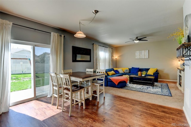 dining area with ceiling fan, wood finished floors, and baseboards