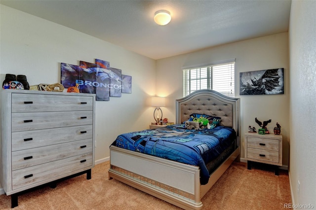 bedroom featuring carpet flooring and baseboards