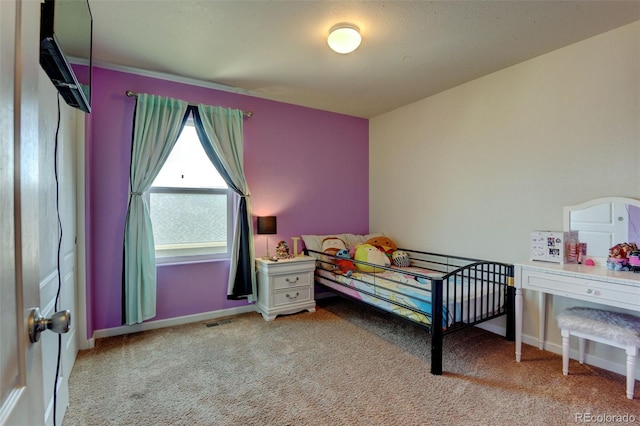 bedroom featuring carpet floors and baseboards