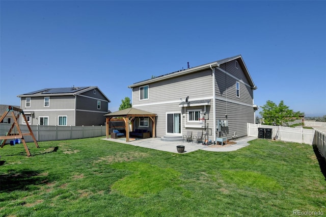 rear view of property featuring a gazebo, an outdoor hangout area, entry steps, a patio area, and a playground