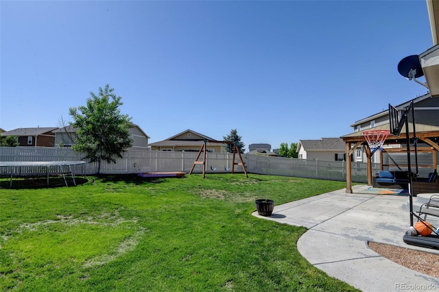 view of yard featuring a trampoline, a gazebo, and a patio area