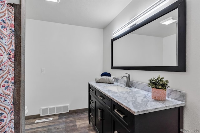 bathroom featuring hardwood / wood-style floors, vanity, and toilet