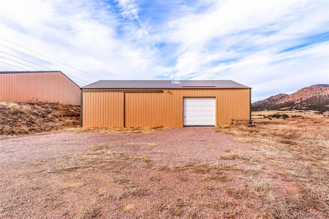 view of outbuilding featuring a mountain view and a garage