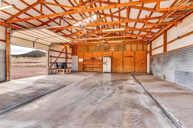 garage with white refrigerator with ice dispenser