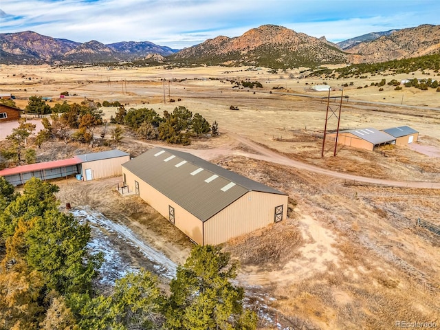 birds eye view of property with a mountain view and a rural view