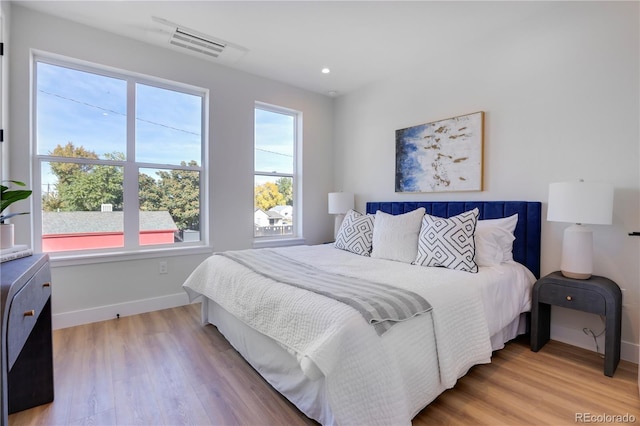 bedroom with baseboards, light wood-style flooring, and recessed lighting