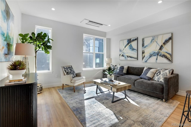 living area featuring plenty of natural light, wood finished floors, recessed lighting, and baseboards