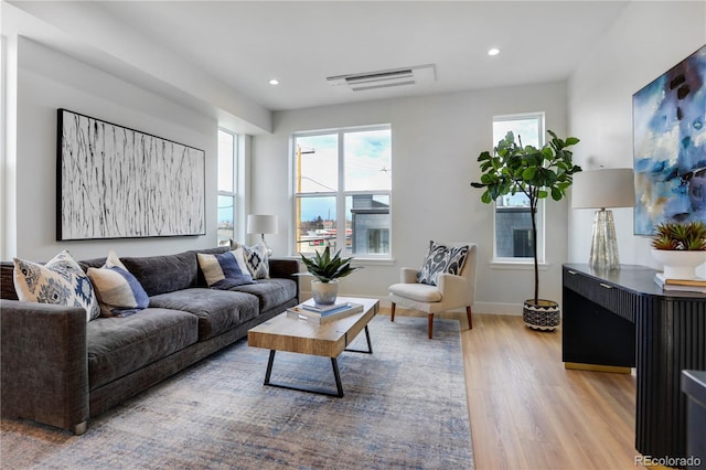 living area featuring light wood-style floors, recessed lighting, and baseboards