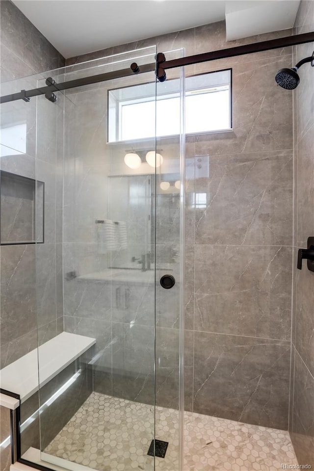 full bathroom with plenty of natural light and a shower stall