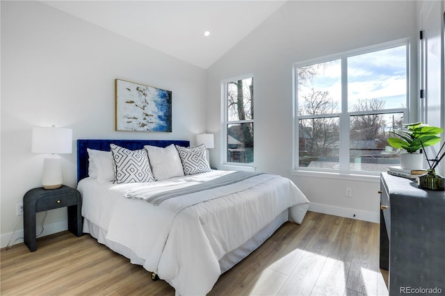 bedroom with light wood-style flooring, baseboards, lofted ceiling, and recessed lighting