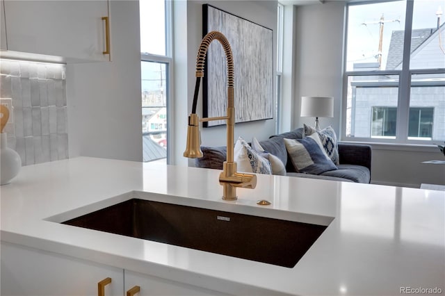 kitchen featuring light countertops and a sink