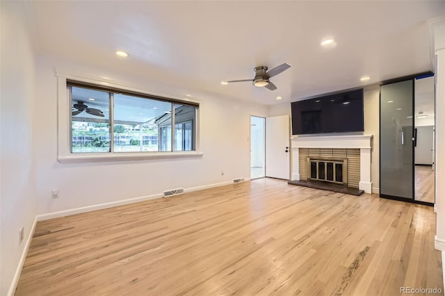 4244 W Monmouth Ave, Littleton, CO 80123 - unfurnished living room with ceiling fan, light wood-style floors, a glass covered fireplace, and recessed lighting