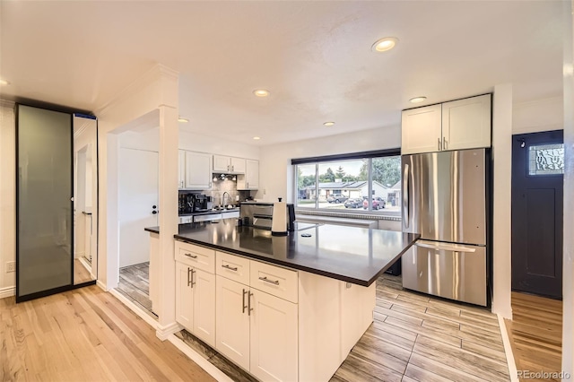 4244 W Monmouth Ave, Littleton, CO 80123 - kitchen with freestanding refrigerator, dark countertops, white cabinets, light wood-style flooring, and recessed lighting