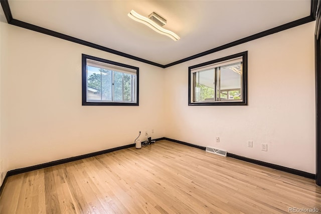 4244 W Monmouth Ave, Littleton, CO 80123 - unfurnished room featuring crown molding and light wood-style flooring