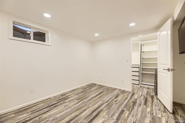 4244 W Monmouth Ave, Littleton, CO 80123 - unfurnished bedroom with wood finished floors, a walk in closet, recessed lighting, and a closet