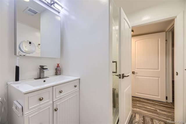 4244 W Monmouth Ave, Littleton, CO 80123 - bathroom featuring vanity and wood finished floors