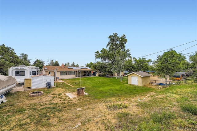 4244 W Monmouth Ave, Littleton, CO 80123 - view of yard featuring a storage shed and a fire pit