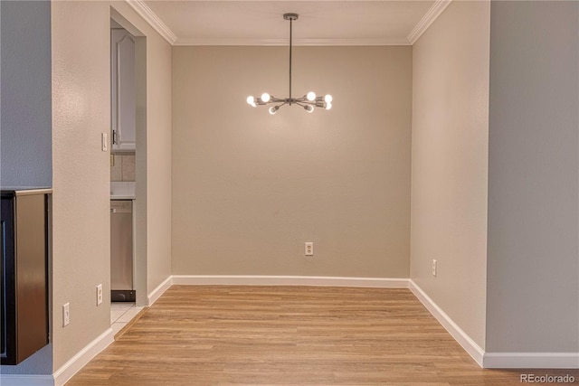 unfurnished dining area with crown molding, a chandelier, and light hardwood / wood-style flooring