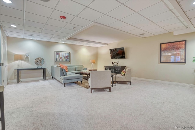 living room featuring carpet floors and a paneled ceiling