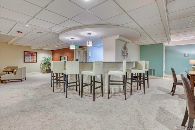 interior space featuring bar and a paneled ceiling