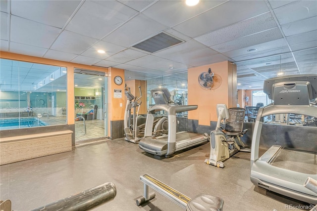 gym featuring a drop ceiling