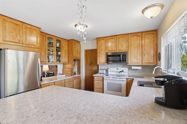 1601 Columbine Pl, Colorado Springs, CO 80907 - kitchen featuring appliances with stainless steel finishes, backsplash, and glass insert cabinets