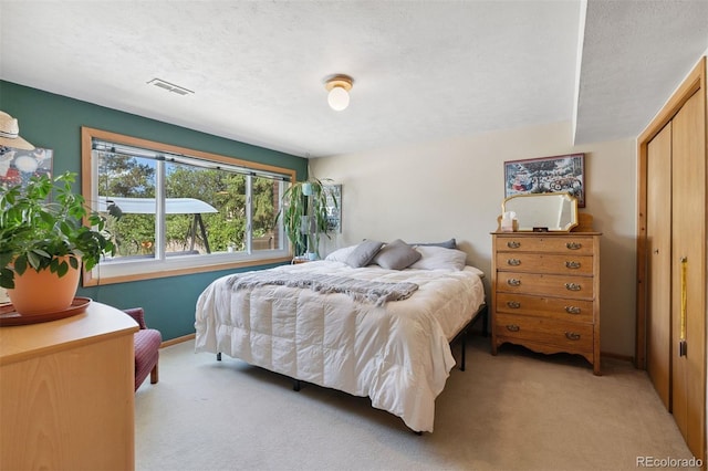 1601 Columbine Pl, Colorado Springs, CO 80907 - bedroom featuring light colored carpet and a textured ceiling