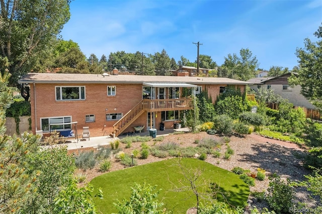1601 Columbine Pl, Colorado Springs, CO 80907 - back of property featuring a deck, stairway, a patio, and brick siding
