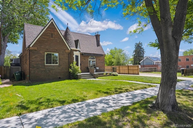 4434 Grove St, Denver, CO 80211 - tudor home featuring brick siding, a chimney, and crawl space