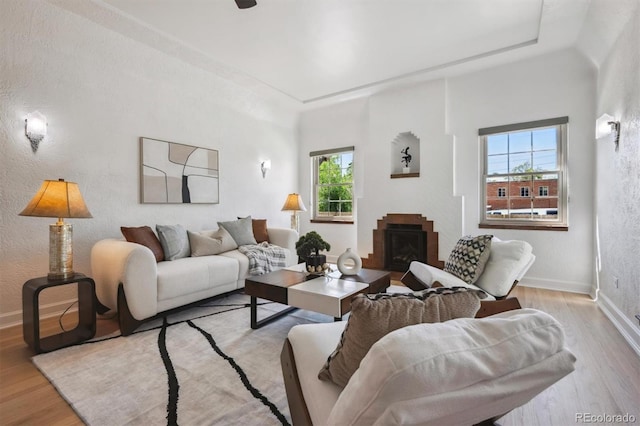 4434 Grove St, Denver, CO 80211 - living room with wood finished floors, a fireplace, baseboards, and a textured wall