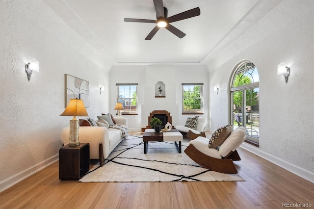 4434 Grove St, Denver, CO 80211 - living area featuring a textured wall, healthy amount of natural light, wood finished floors, a ceiling fan, and baseboards