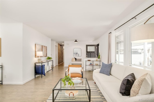 living area with wood finished floors and baseboards