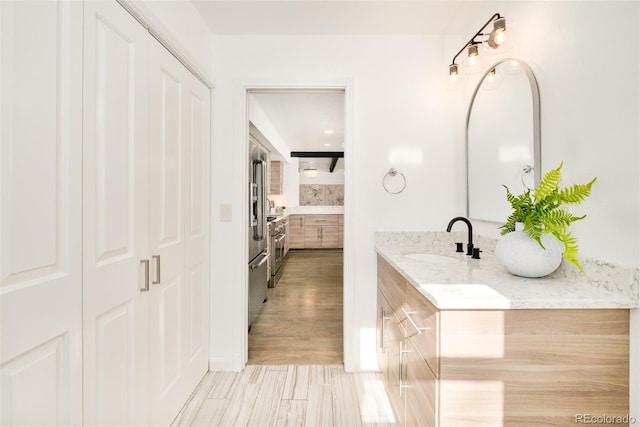 bathroom featuring a closet and vanity