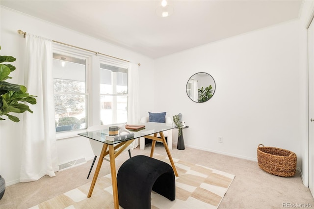 office featuring light carpet, visible vents, and baseboards