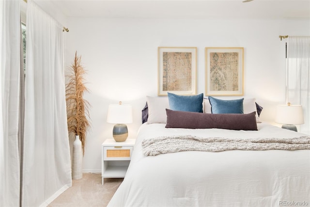 carpeted bedroom featuring baseboards