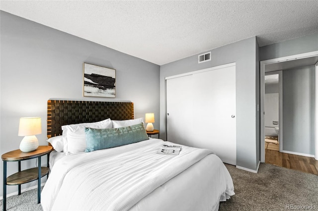 8600 E Alameda Ave Unit 13-108, Denver, CO 80247 - bedroom featuring carpet floors, a closet, and a textured ceiling