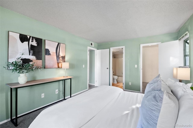 8600 E Alameda Ave Unit 13-108, Denver, CO 80247 - bedroom featuring a textured ceiling and ensuite bath