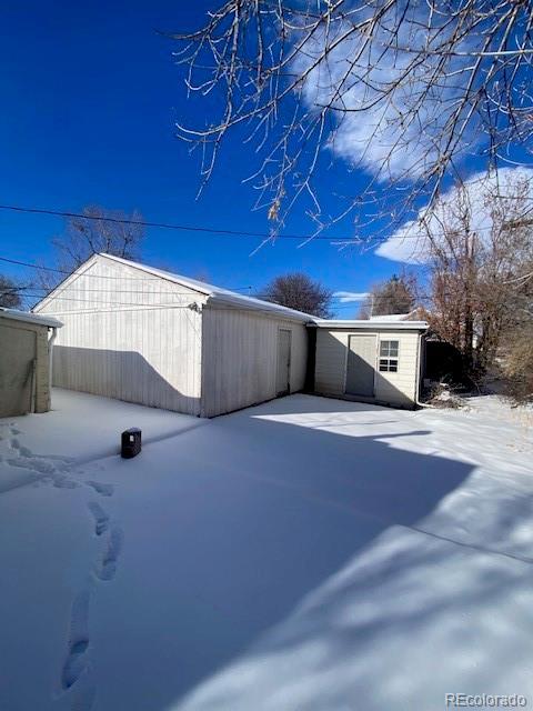 snow covered property featuring a patio