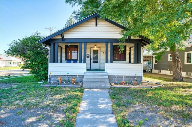 bungalow-style house with a porch and a front yard