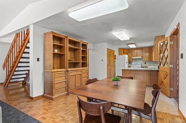 561 Quartz Cir, Bailey, CO 80421 - dining space featuring stairway and a textured ceiling