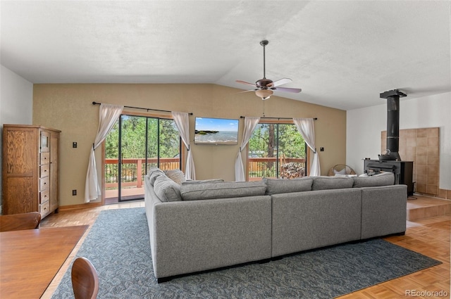 561 Quartz Cir, Bailey, CO 80421 - living area with a ceiling fan, lofted ceiling, a wood stove, and a textured ceiling
