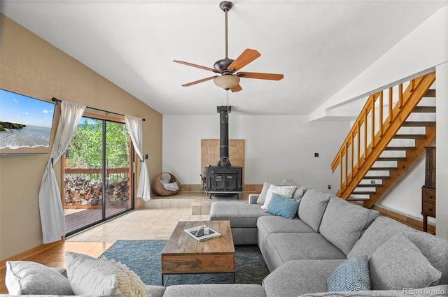 561 Quartz Cir, Bailey, CO 80421 - living area featuring lofted ceiling, stairs, ceiling fan, and a wood stove